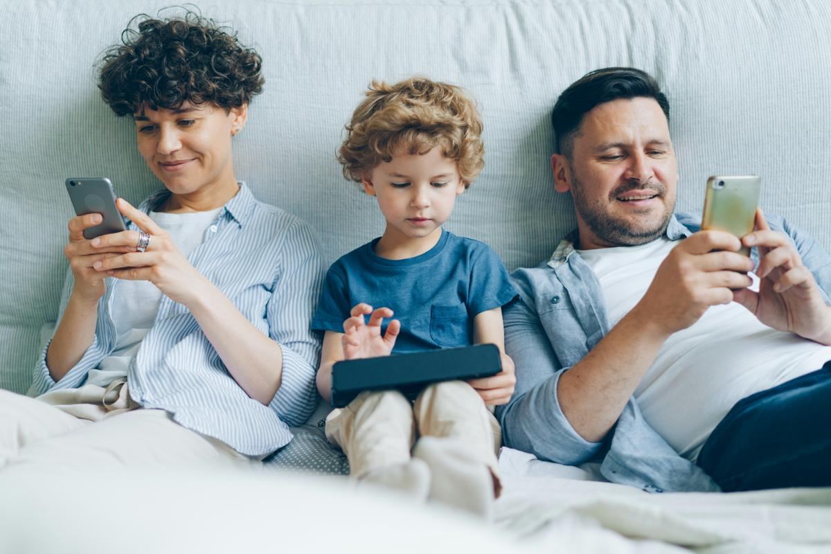 Family using digital devices together